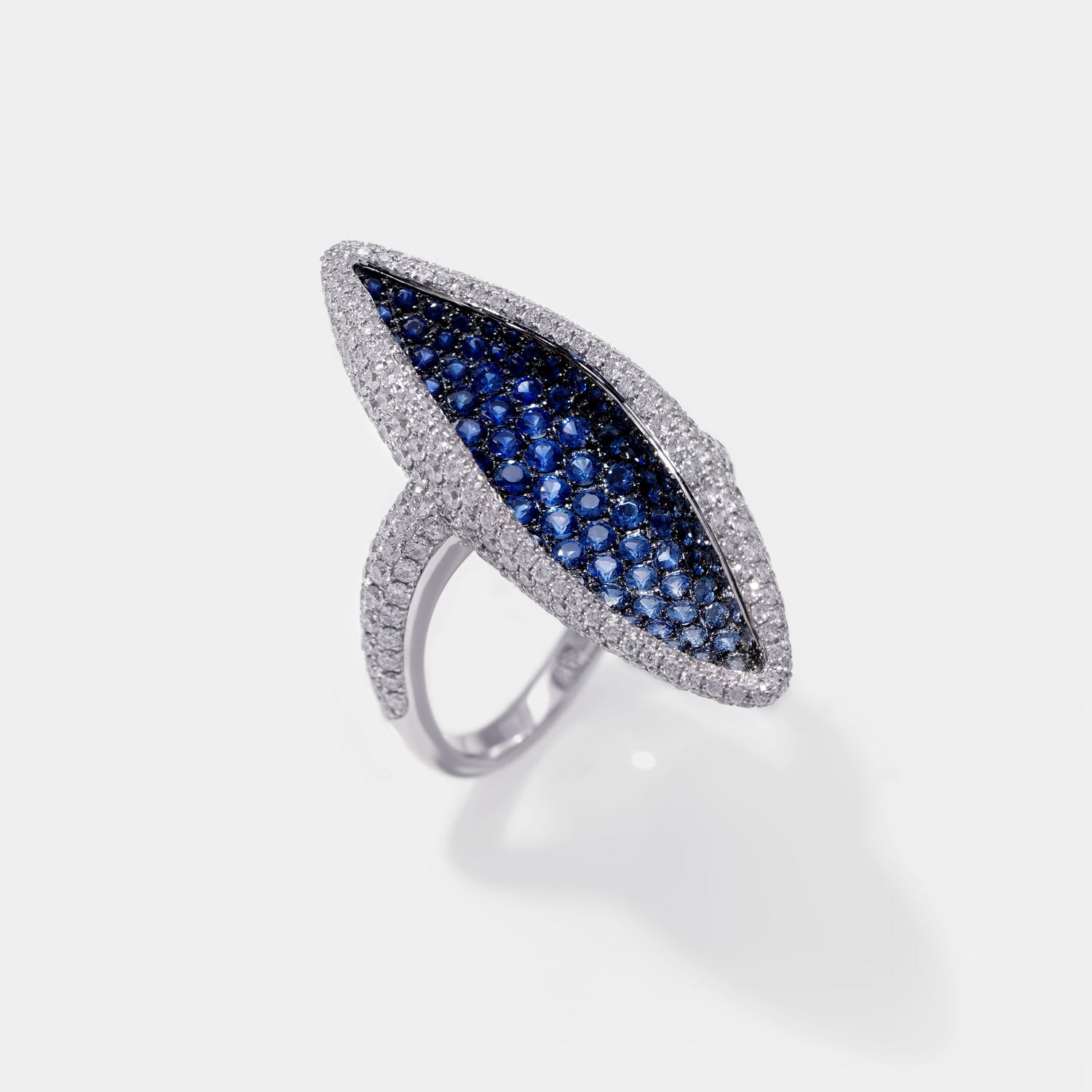 Gold ring with blue sapphires in microscope pavee setting